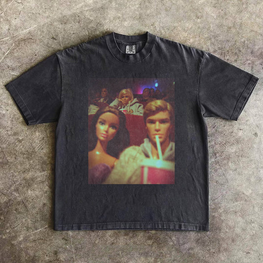 COUPLE WEARING BARBIECORE T-SHIRTS WHILE WATCHING A MOVIE.